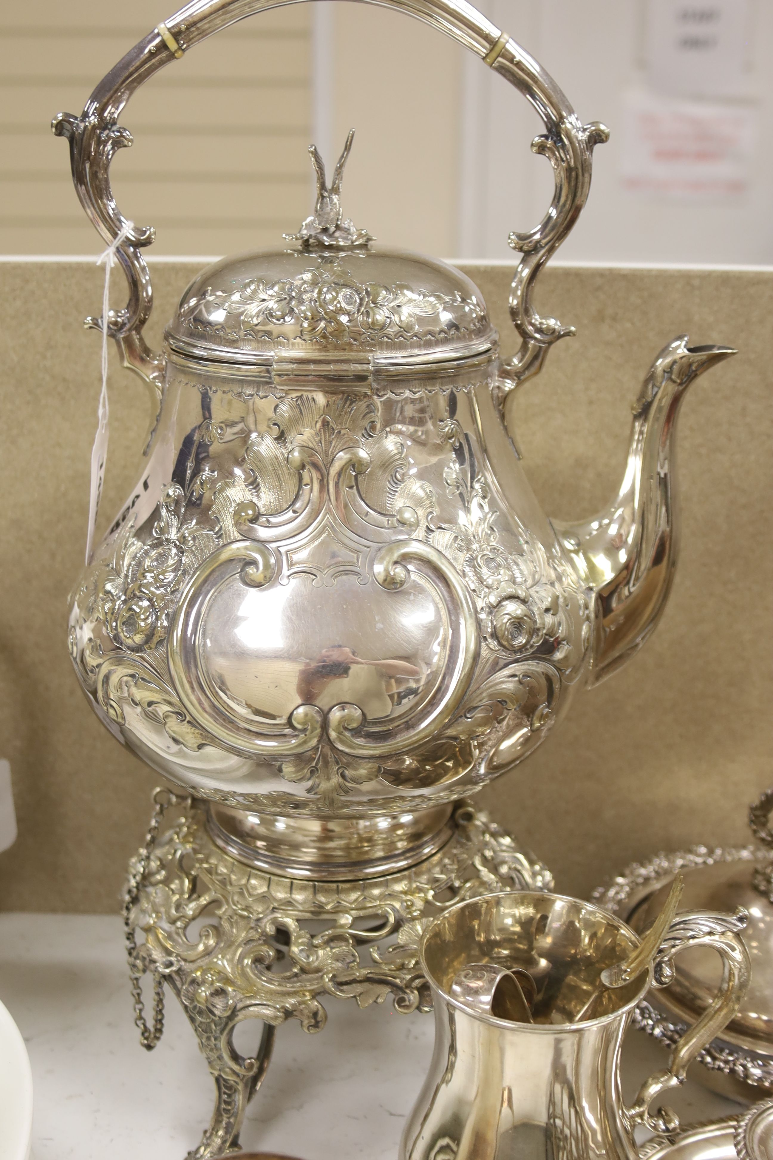 A silver plated tea kettle on stand with burner, 54cm high, and a small quantity of other plated items.